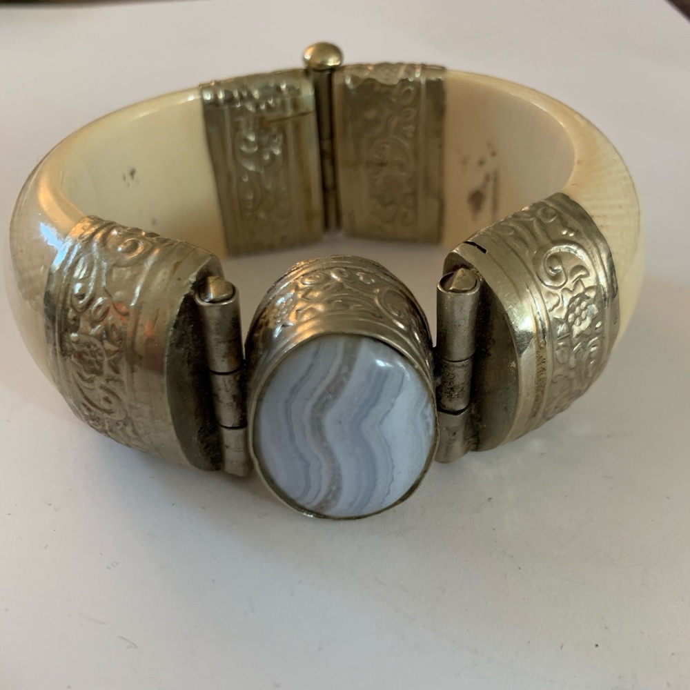 Ivory bracelet with blue stone.
